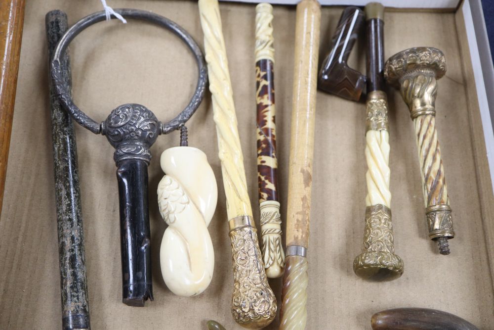 A group of silver, gilt metal and ivory walking cane and parasol handles.